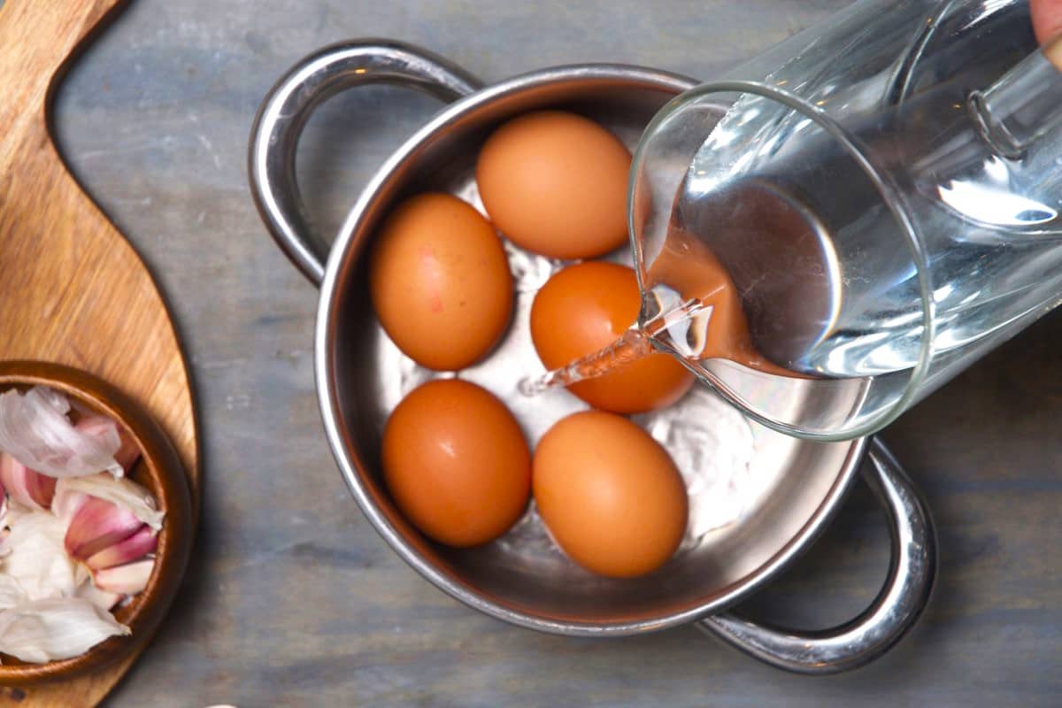 Eggs in saucepan with water.