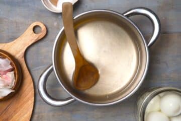 Saucepan with pickling brine and wooden spoon.