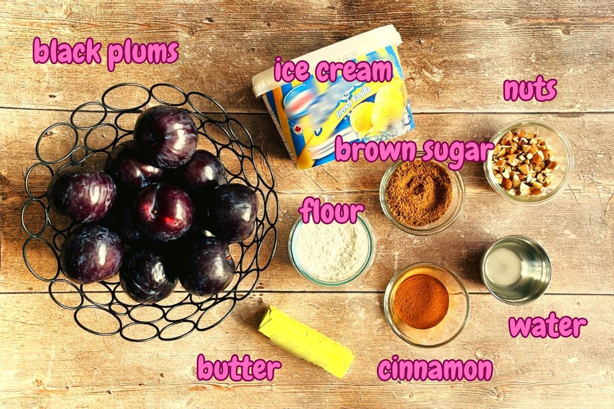 Plum crumble ingredients labeled on wooden background.