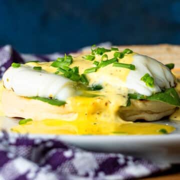 Runny poached eggs on an English muffin with mock bearnaise sauce.
