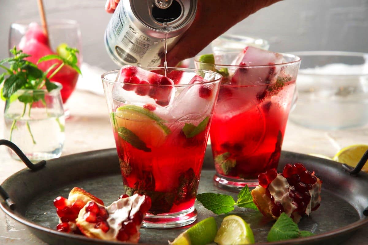 Club soda pouring over pomegranate drink.