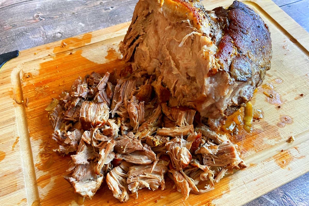 Shredded pork on cutting board.