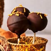 Pumpkin cake pops in small basket.