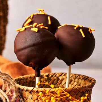 Pumpkin cake pops in small basket.