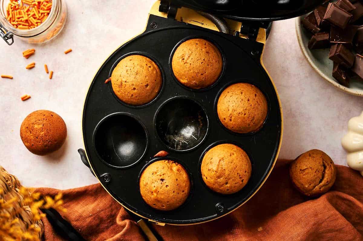 Pumpkin cake balls in cake pop maker.
