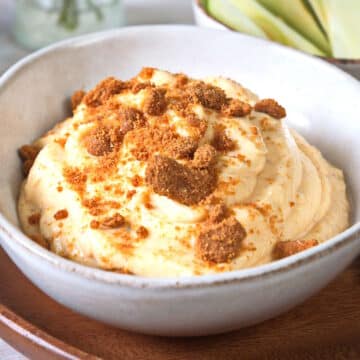Pumpkin fluff dip in a bowl with crushed Biscoff cookies.