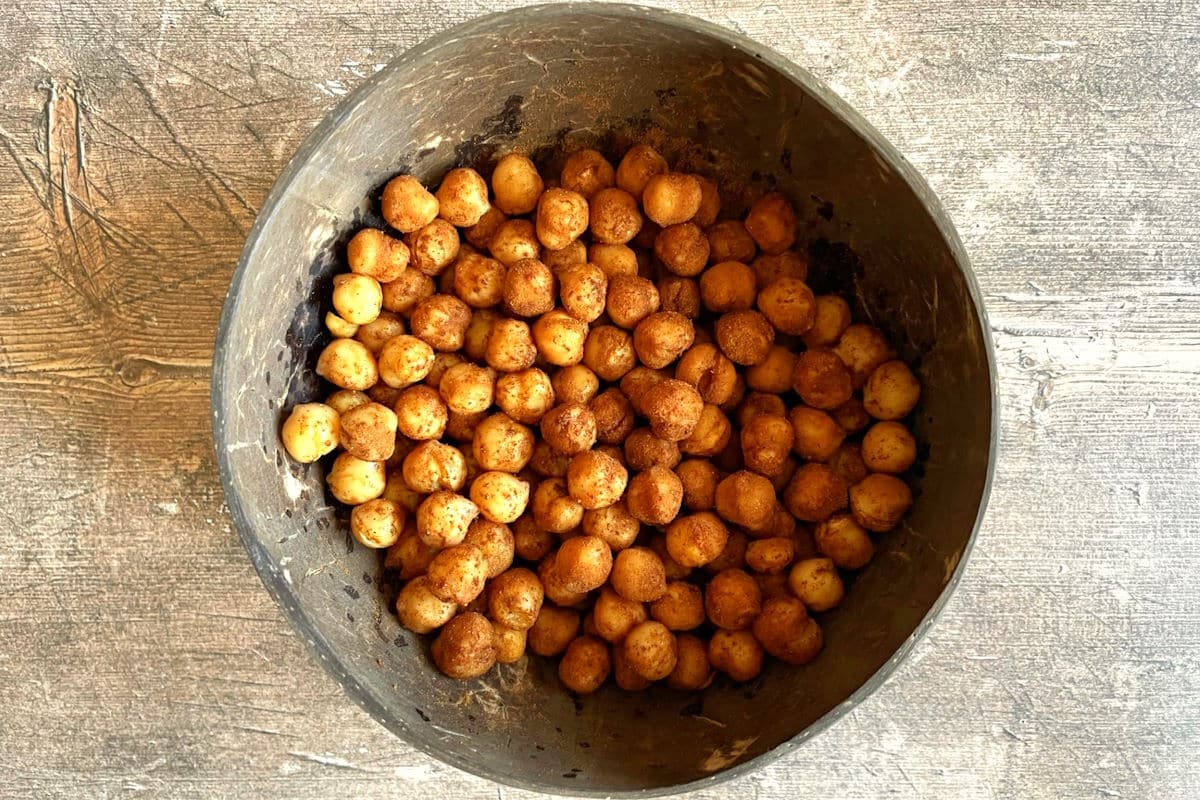 Chickpeas tossed with pumpkin pie spices in a bowl.