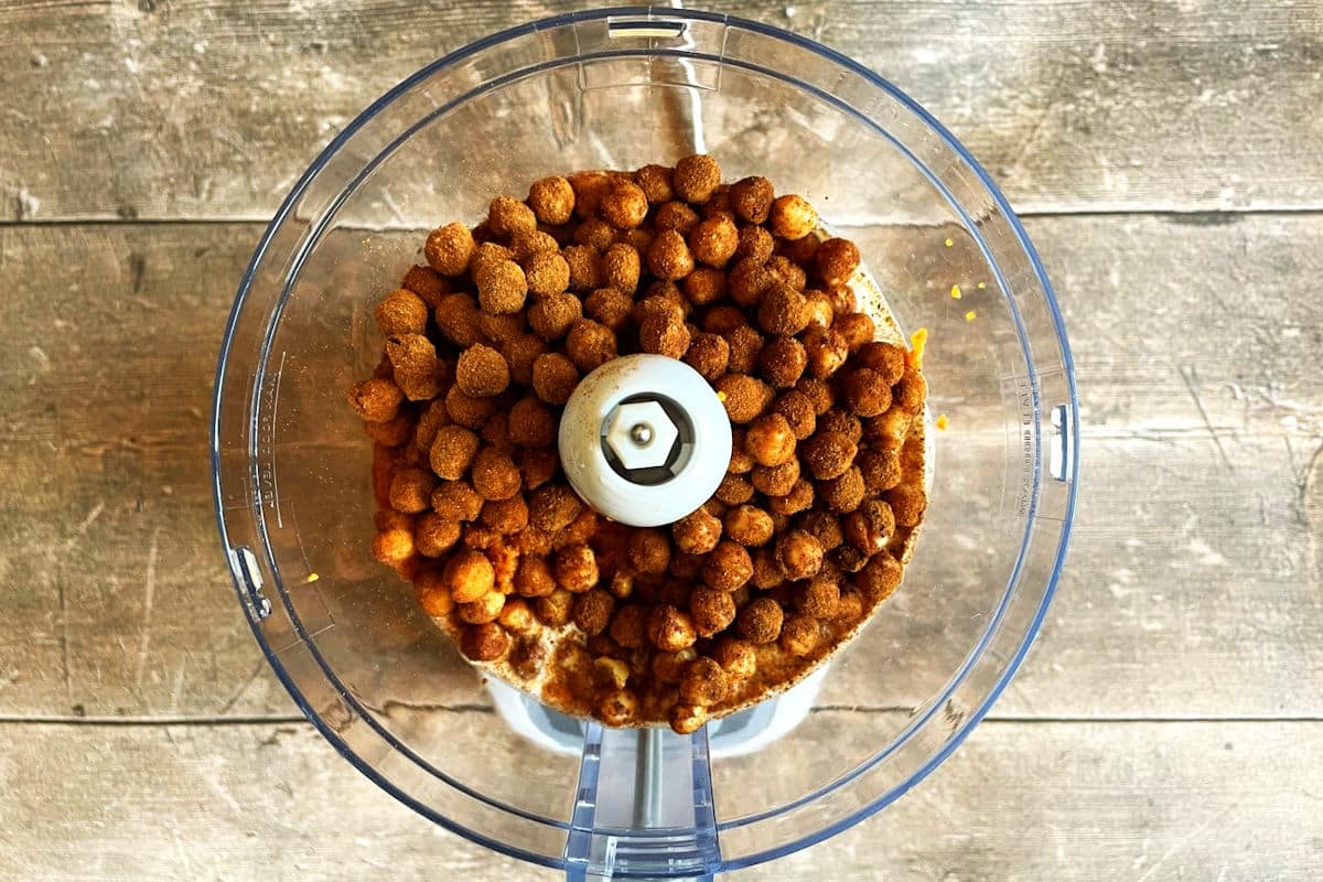 Pumpkin pie hummus ingredients in food processor.