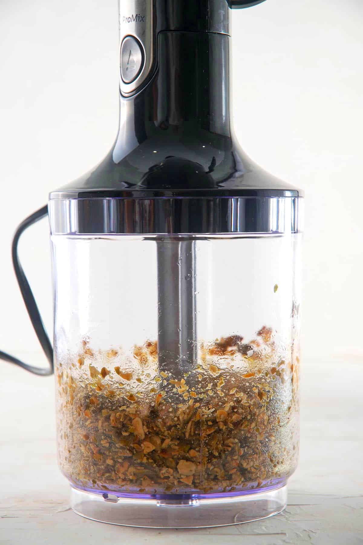 Pumpkin seeds with oil and salt in food processor.