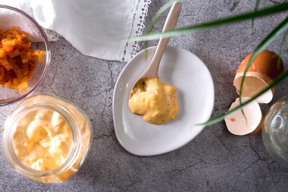 Kimchi mayo on small plate with spoon.