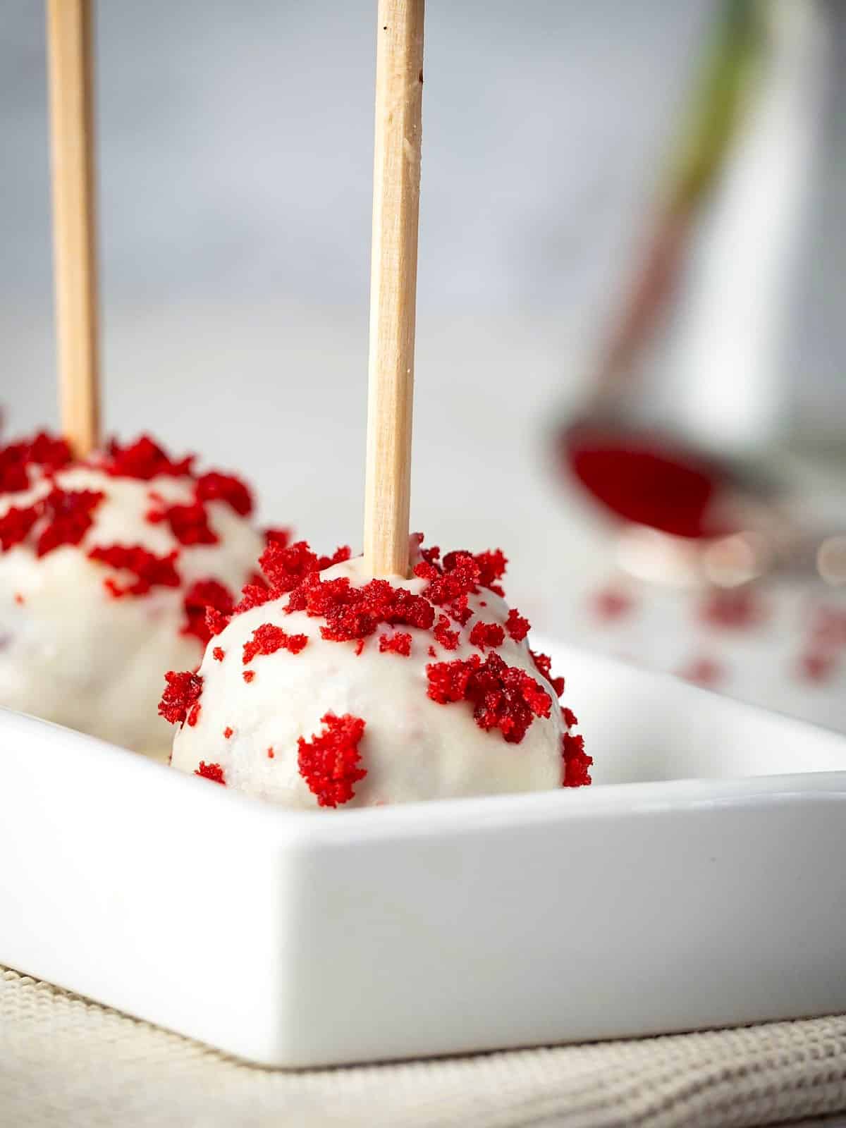 Red velvet cake pops with red velvet crumble topping.