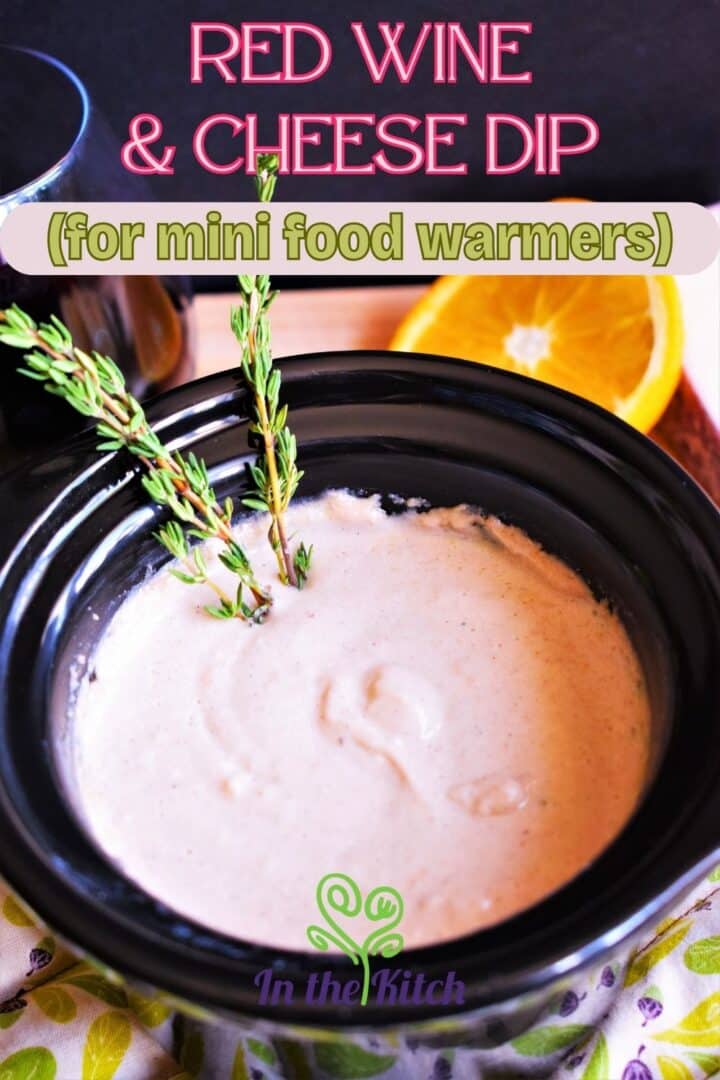 Red wine cheese dip in mini slow cooker on pot holder.