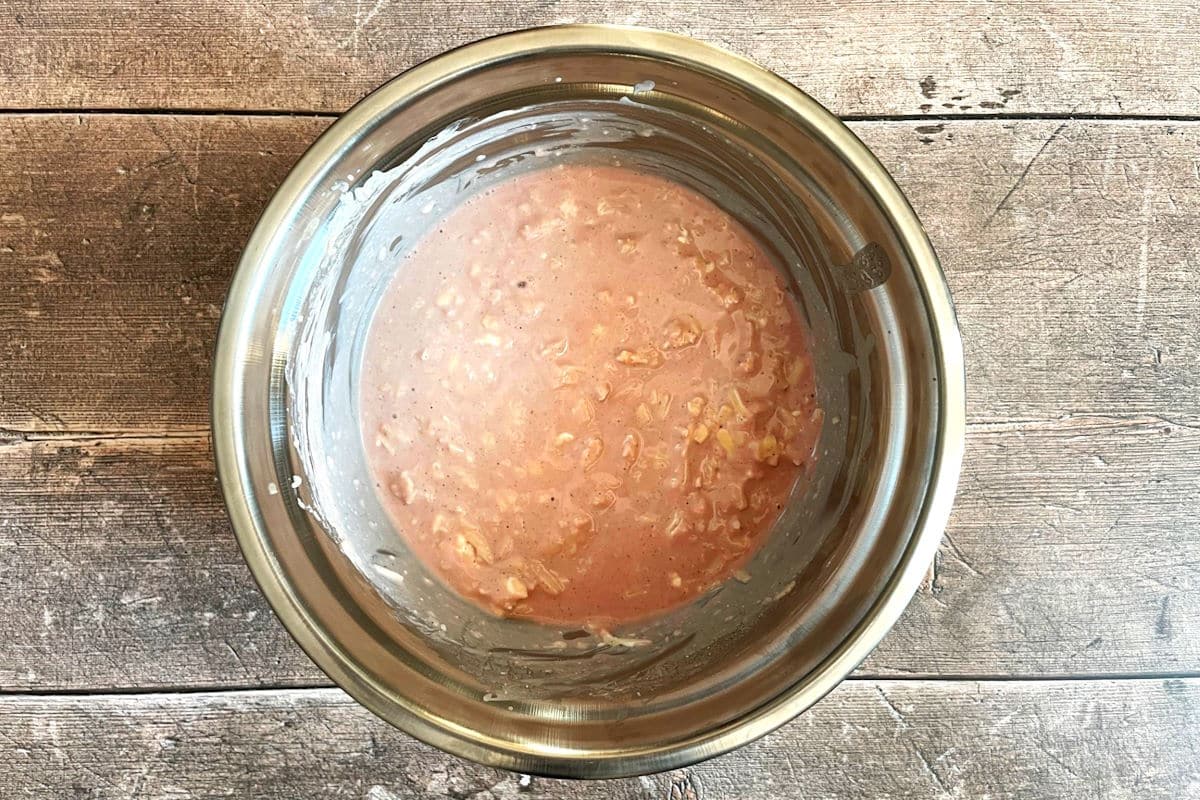 Red wine cheese dip ingredients combined in bowl.
