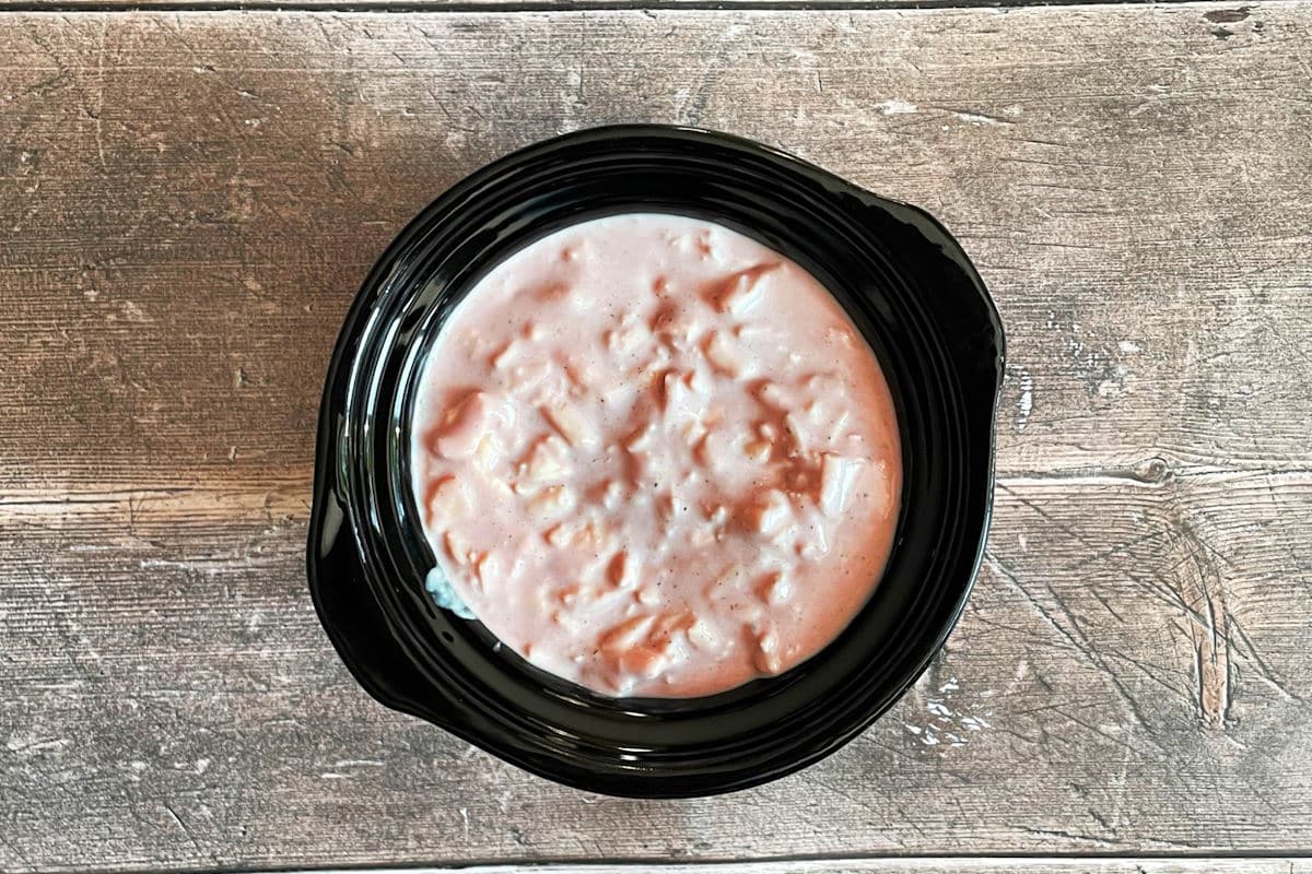 Red wine cheese dip ingredients in mini slow cooker.
