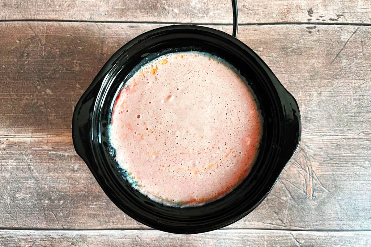 Hot red wine cheese dip in mini slow cooker.