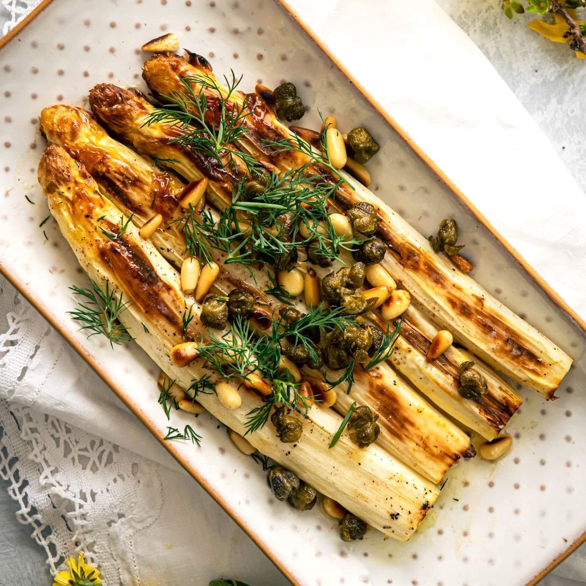 Roasted white asparagus with capers and fresh dill.