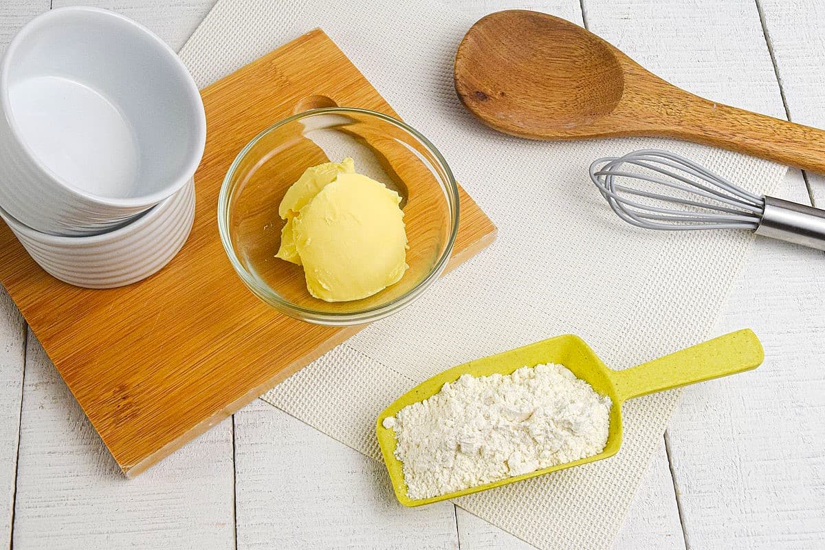 How to Make a Roux_1-2 Roux ingredients prepped on white wooden background.