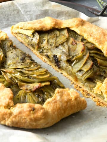 Potato galette with basil pesto sliced in half.