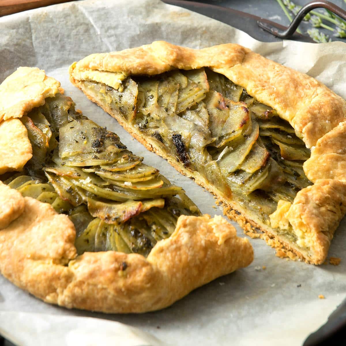 Potato galette with basil pesto sliced in half.