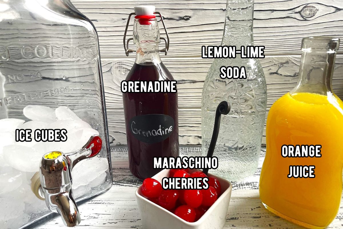 Shirley temple punch ingredients prepped and labeled on white wooden background.