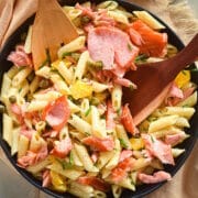 Smoked salmon pasta salad in black dish.
