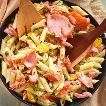 Smoked salmon pasta salad in black dish.