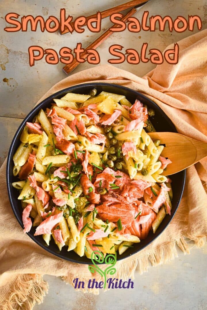 Smoked salmon pasta salad in black dish with text overlay.