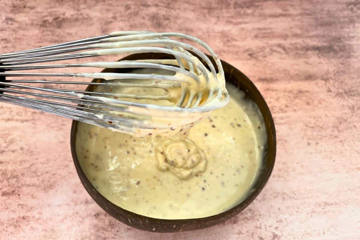 Whisk in bowl of smoky maple burger sauce.