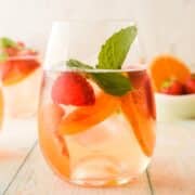 Spring white wine sangria in wine glass.
