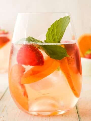 Spring white wine sangria in wine glass.
