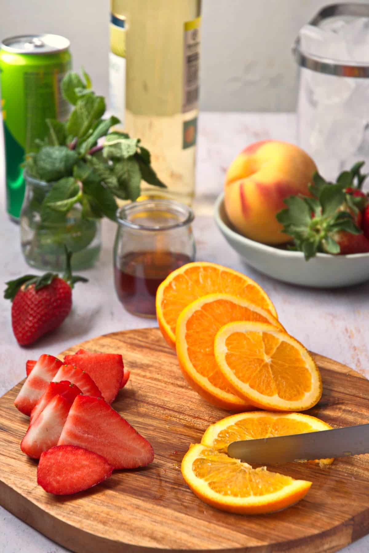 Fresh oranges sliced on cutting board.