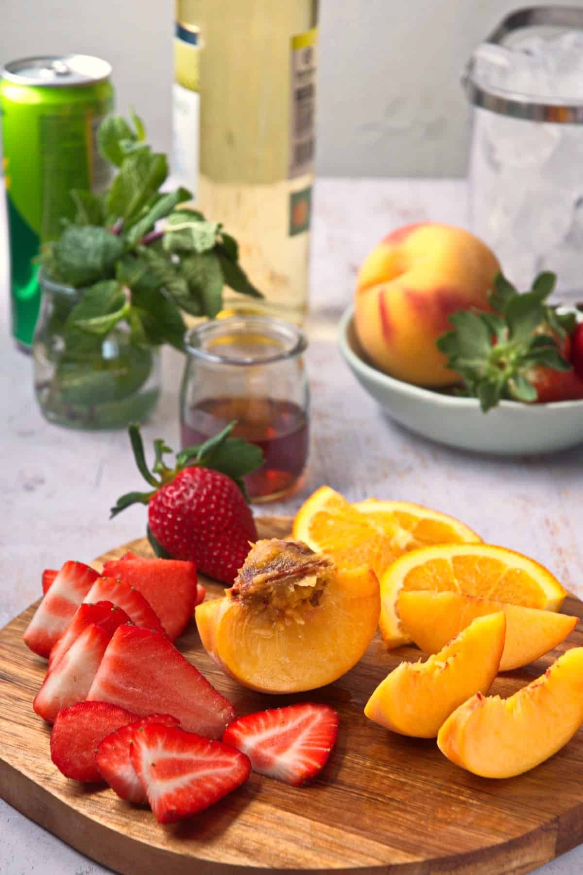 Fresh fruit sliced on cutting board.