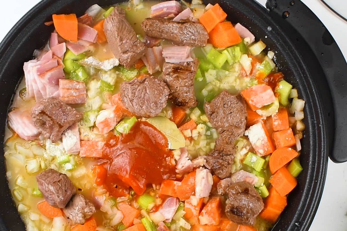 Beef stew ingredients in electric skillet.