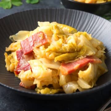 Cabbage and bacon in bowl.