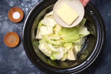 Raw green cabbage and butter in slow cooker.