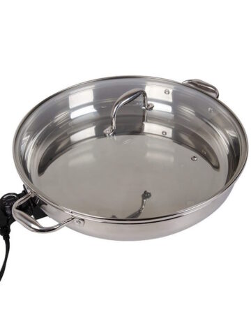 Stainless steel electric skillet isolated on white background.