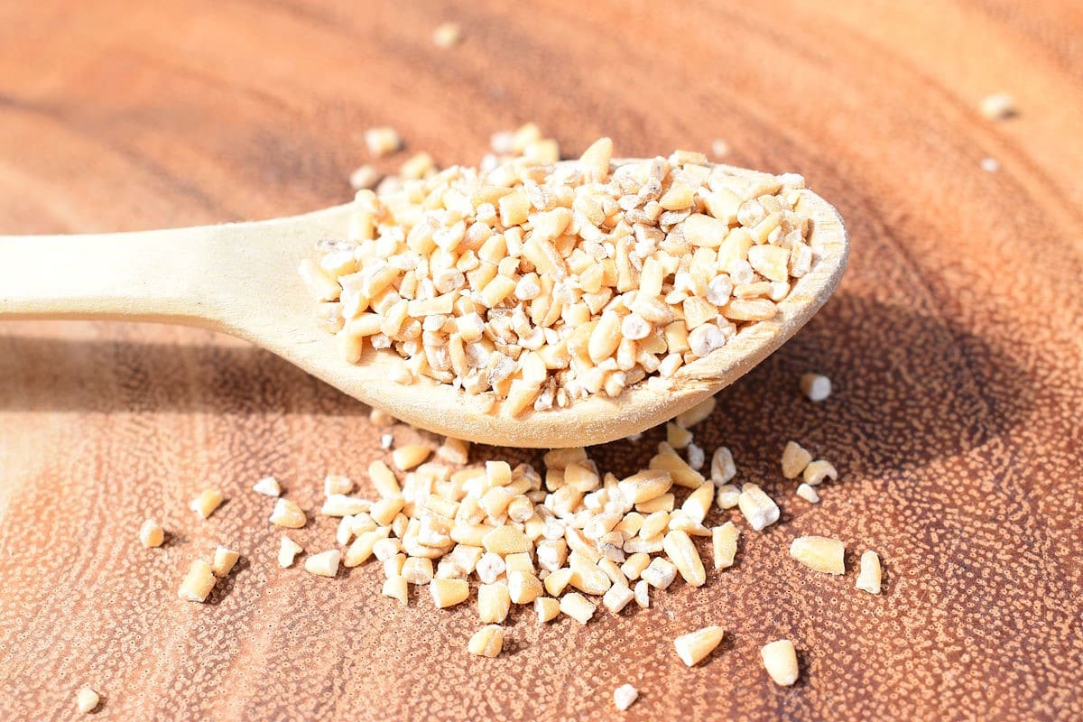 Steel Cut Oats 3 Steel cut oats on wooden spoon.