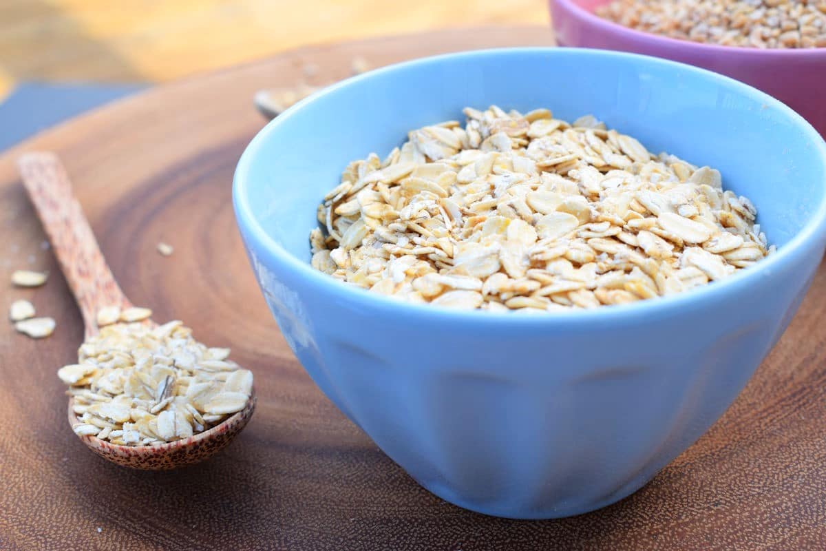 Rolled Oats 5 Rolled oats in blue bowl and wooden spoon.