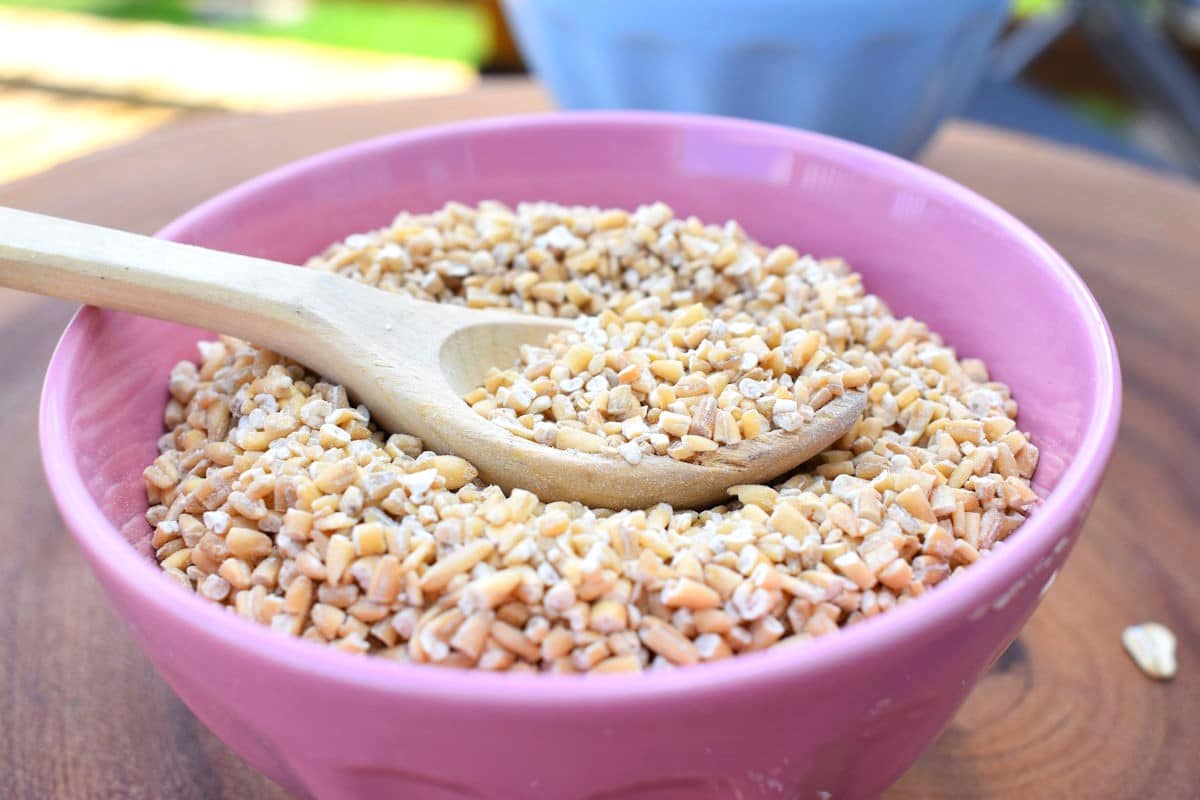 Steel Cut Oats 2 Steel cut oats in pink bowl with wooden spoon.