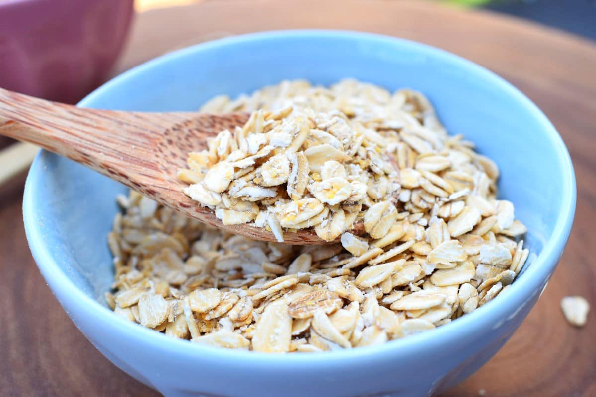 Rolled Oats 2 Rolled oats in blue bowl with wooden spoon.