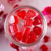 Strawberry heart-shaped candies in jar.