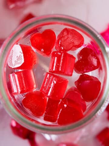 Strawberry heart-shaped candies in jar.