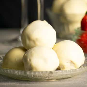 Strawberry champagne cake balls stacked on plate.