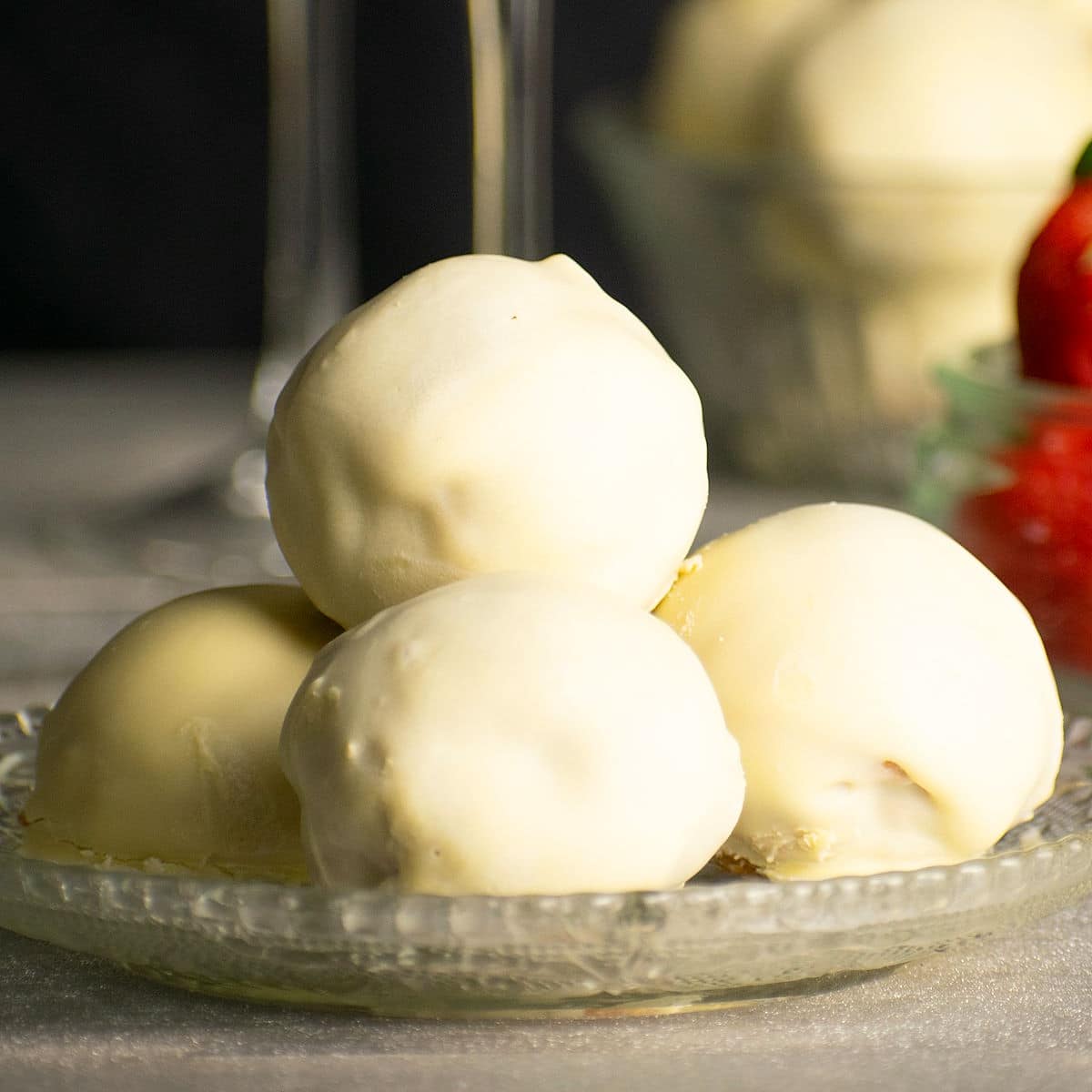 Strawberry champagne cake balls stacked on plate.
