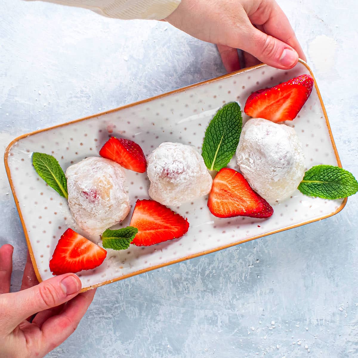 Strawberry mochi on serving dish.
