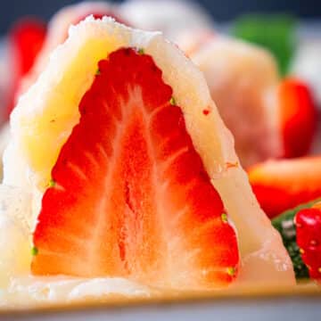 Strawberry mochi cut in half.