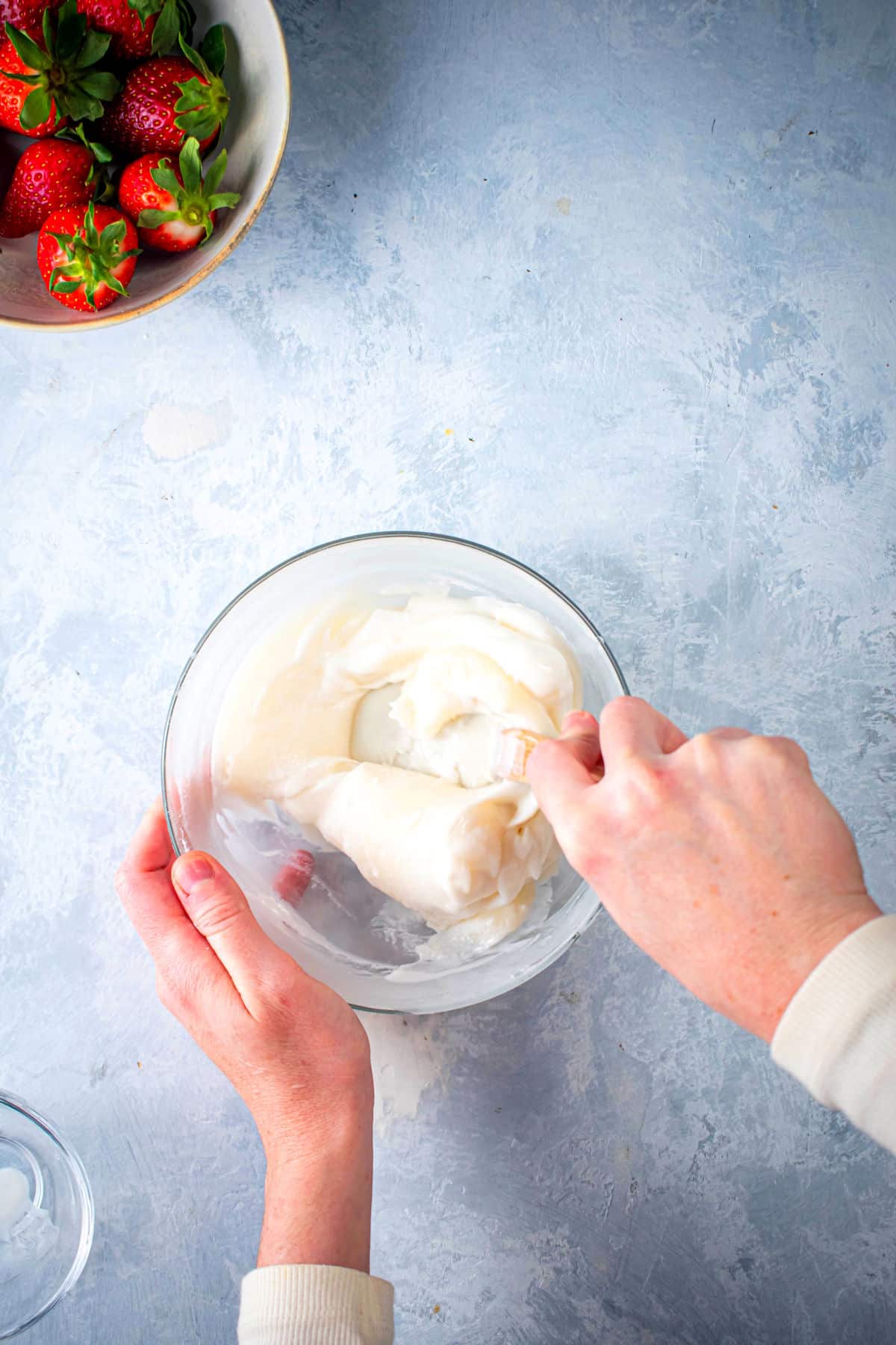 Mochi dough in bowl getting mixed with spatula.