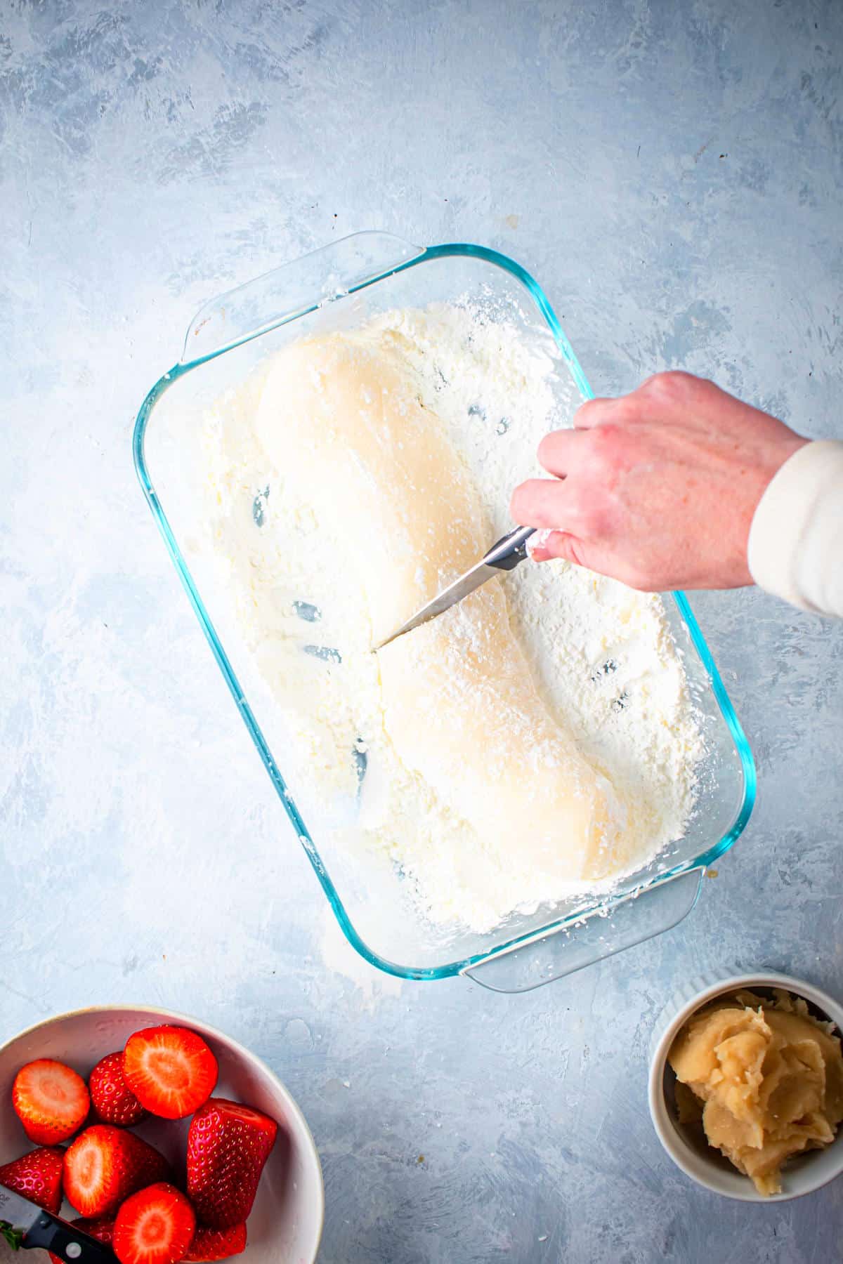 Mochi dough roll getting sliced.