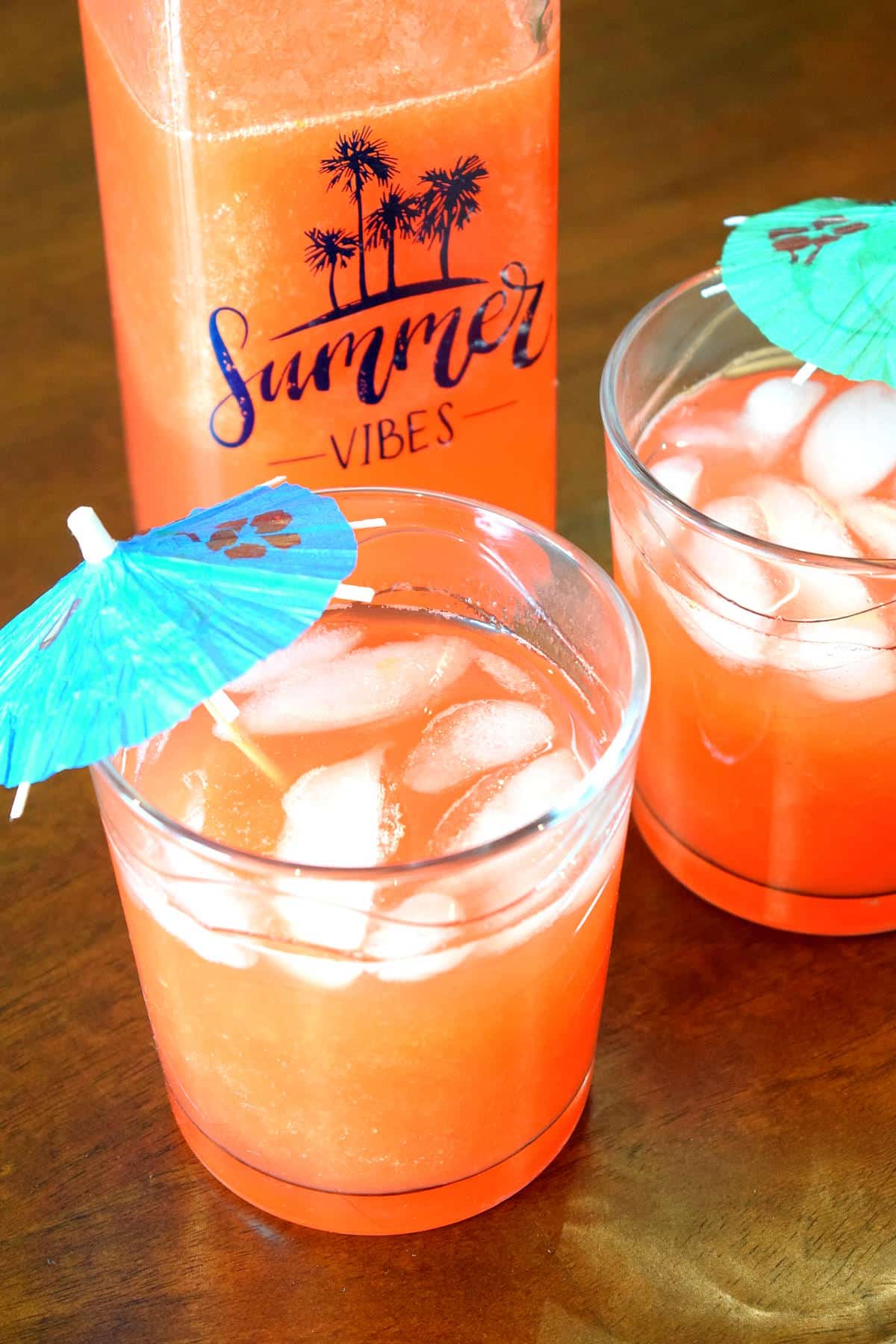 Summer mango pomegranate soda in drinking glasses and glass jar.