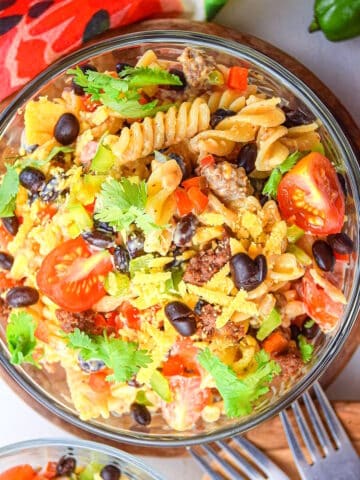Taco pasta salad in a bowl with forks on the side.